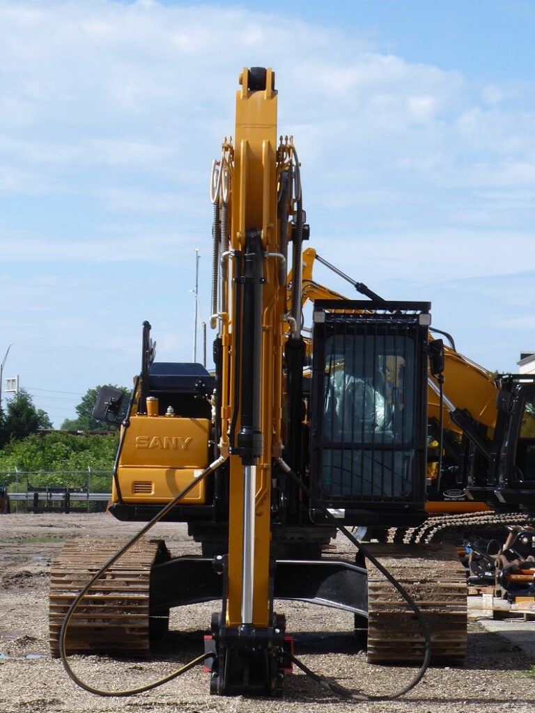 Full-sized excavator with breaker attachment pictured for Construction Equipment Sales in Riverside County CA